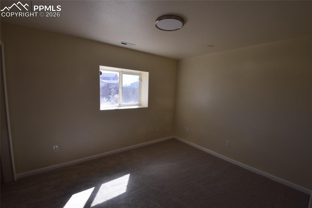 Image 31 of 42: The room features neutral-toned walls, a window providing natural light, an