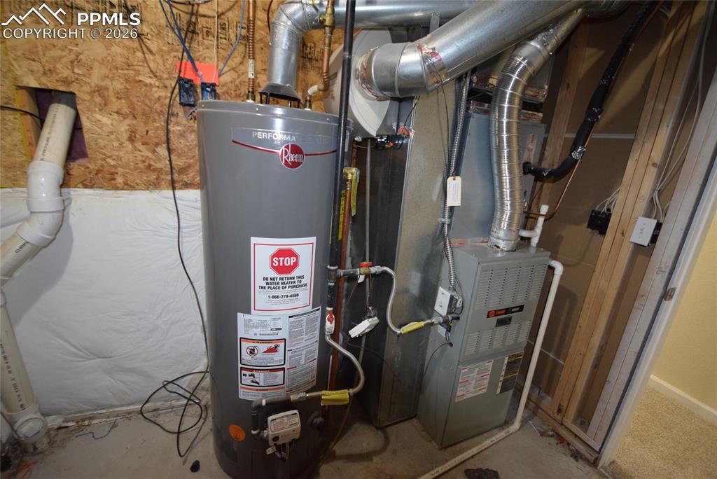 Image 36 of 42: The property features a water heater and a furnace, indicating essential ut