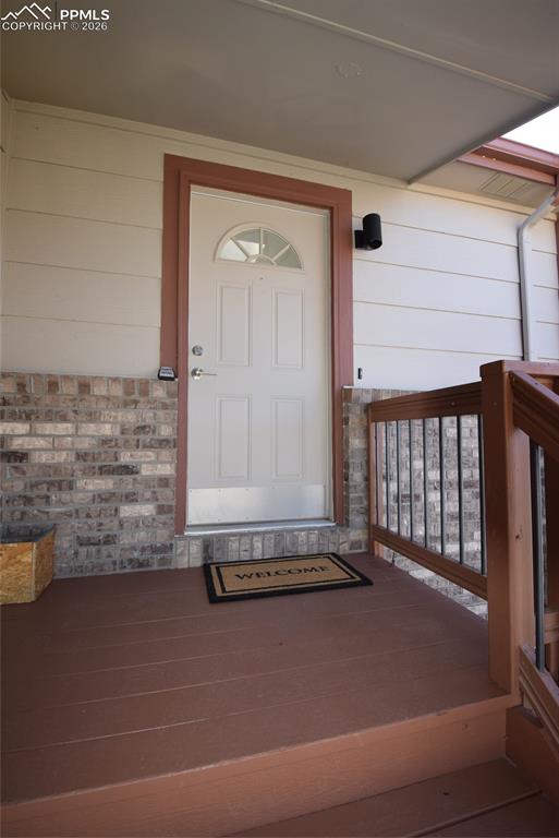 Image 7 of 42: The property features a front door with a decorative window, a covered porc