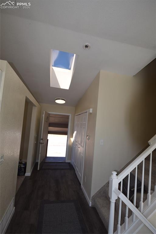 Image 8 of 42: The entryway features a skylight, wood-style flooring, and a carpeted stair