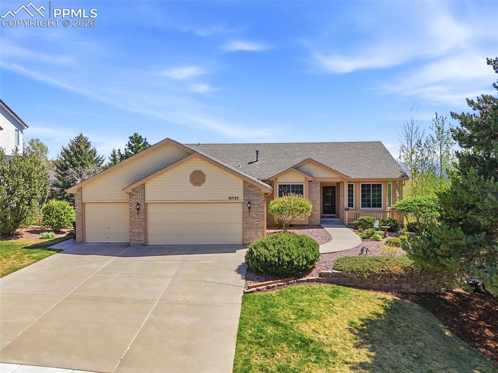 Caption: Ranch-style residence featuring a prominent three-car garage, concrete driveway, and front entryway 