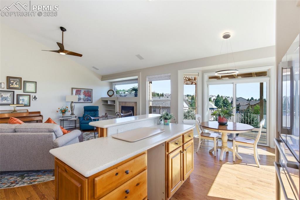 Image 10 of 40: Open-concept living space featuring wood-finish flooring, a kitchen island