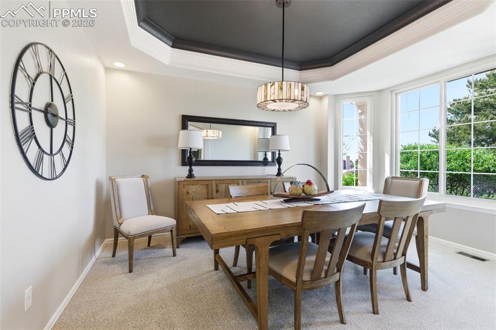 Image 11 of 40: Tray ceiling with dark accent paint and white trim