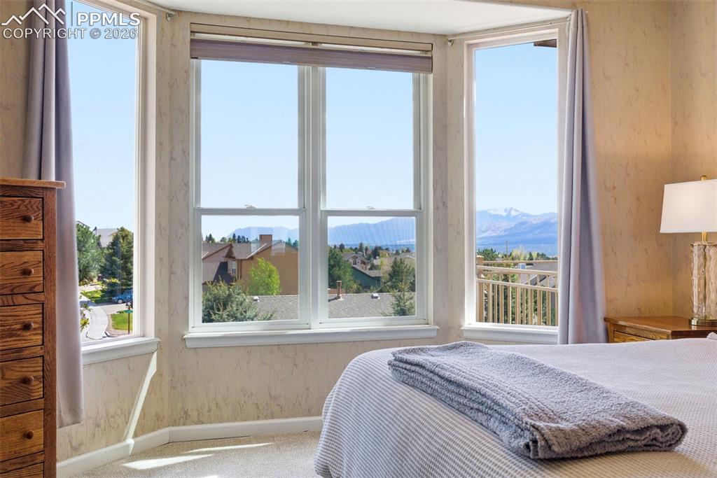 Image 14 of 40: Bay window offering mountain and neighborhood scenery