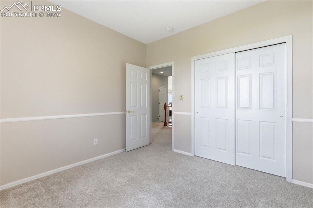 Image 19 of 40: Interior room featuring neutral-toned walls with chair rail molding, light-