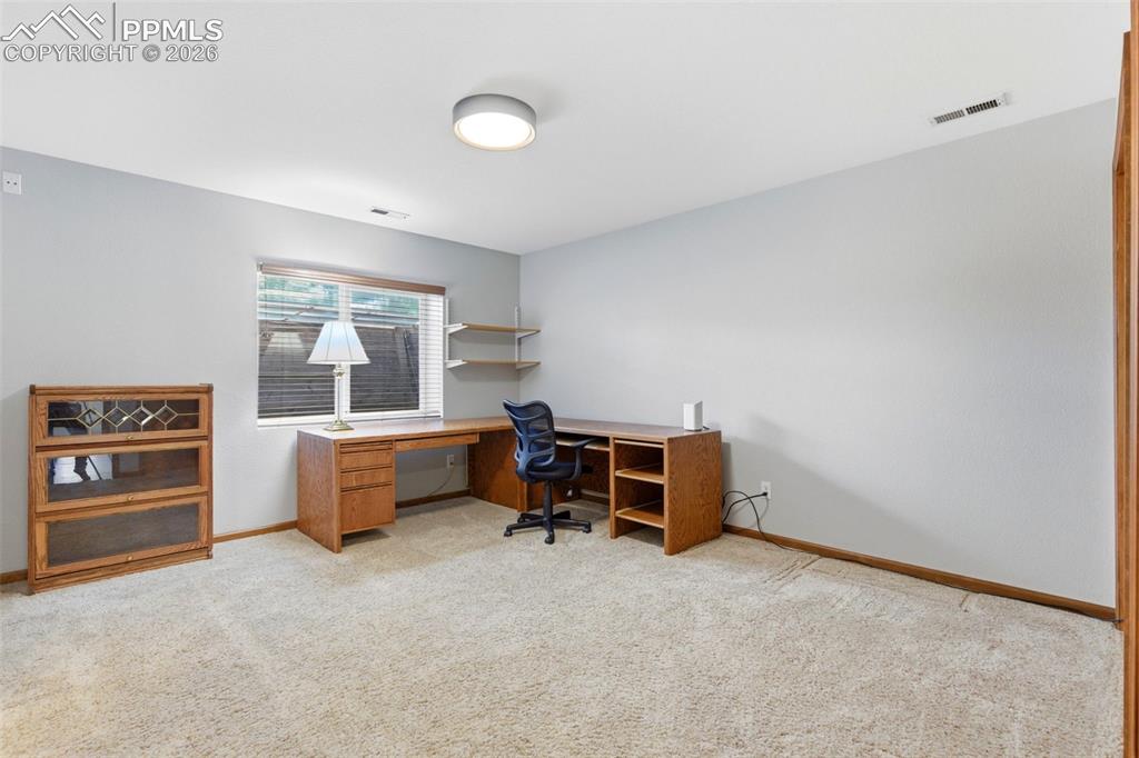 Image 24 of 40: Neutral wall paint and carpeted flooring