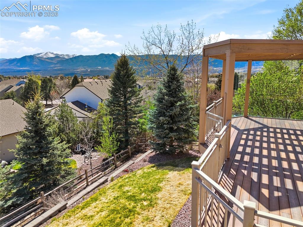 Image 29 of 40: Expansive outdoor deck featuring wood-finish flooring, a pergola, and metal