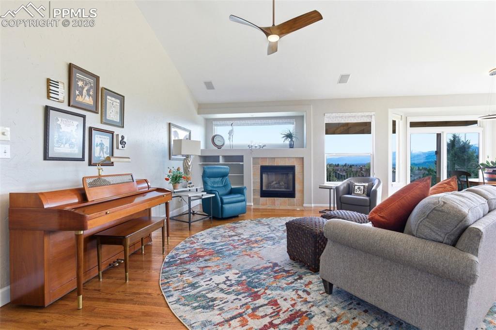 Image 3 of 40: Spacious living area featuring wood-finish flooring, a contemporary ceiling