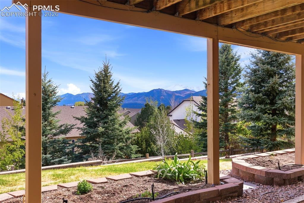 Image 30 of 40: Covered patio featuring exposed wood beams