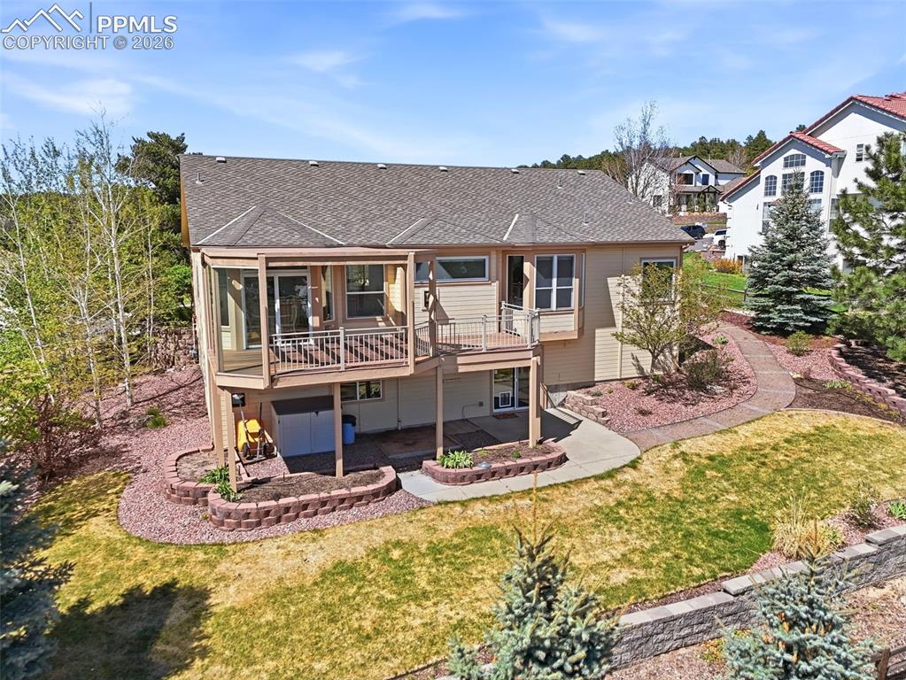 Image 36 of 40: Rear exterior with covered deck and enclosed sunroom