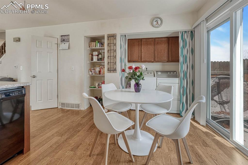 Image 8 of 22: dining area filled with natural light, warm wood-style flooring, and endles