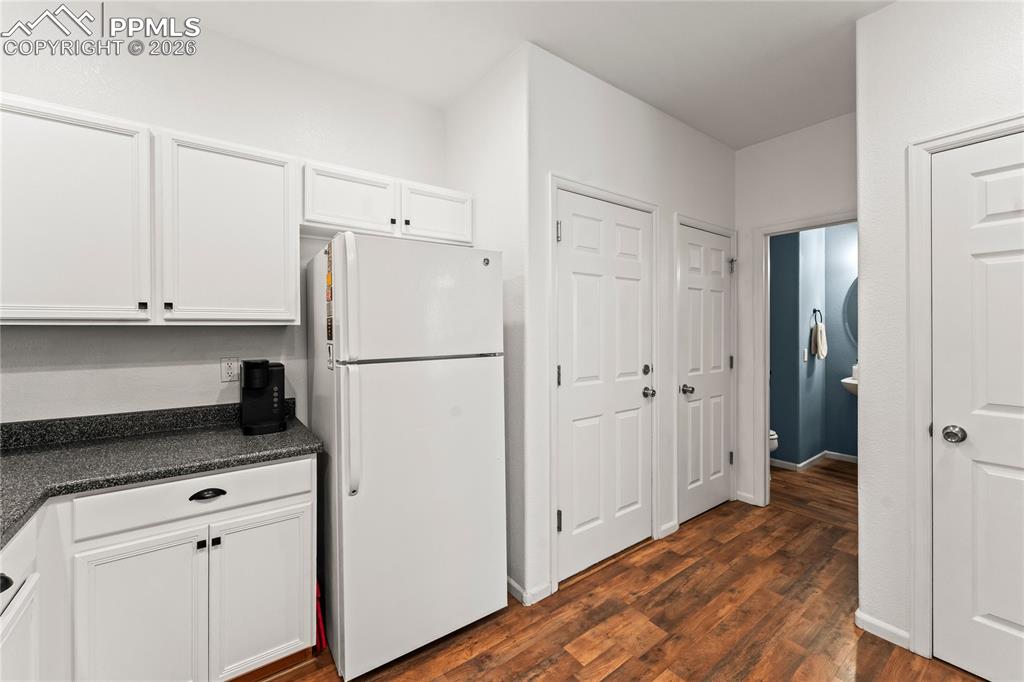 Image 14 of 41: Kitchen looking towards 1/2 bath, garage access, and pantry.