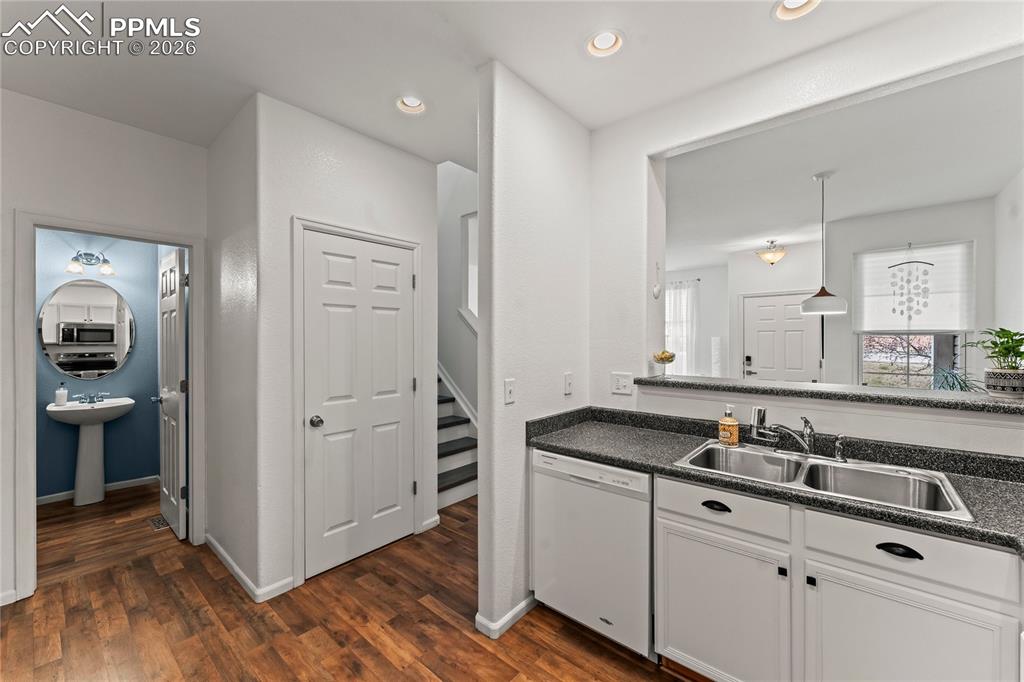 Image 15 of 41: Kitchen looking to half bathroom and utility closet.