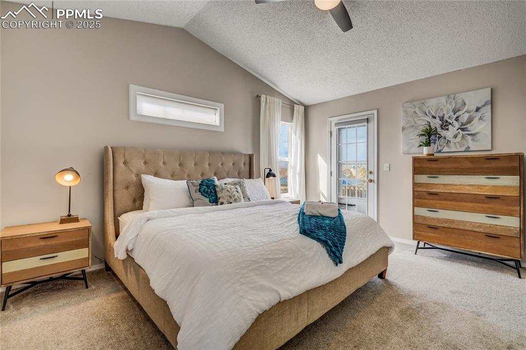 Image 12 of 35: Main floor primary bedroom featuring newer carpet, vaulted ceiling, private