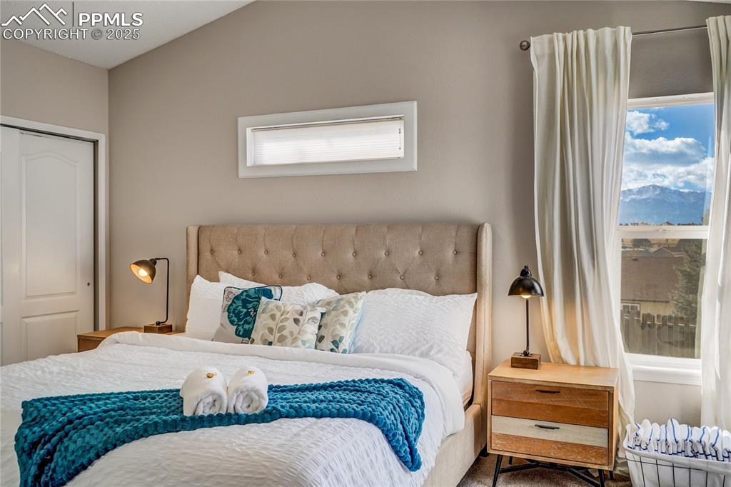 Image 13 of 35: Primary bedroom with views of Pikes Peak
