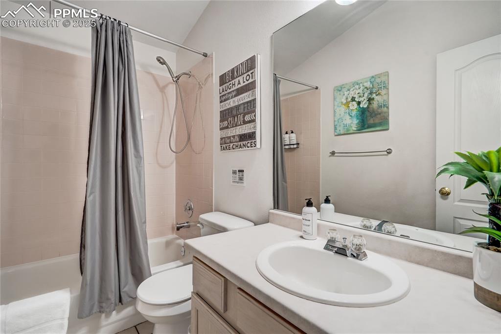Image 19 of 35: Main level full  bathroom featuring shower/tub combo and vanity
