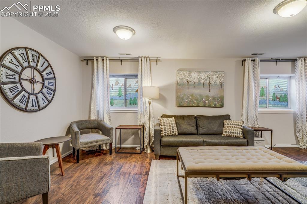 Image 22 of 35: Recreation room in the basement with good lighting, murial painted on the w