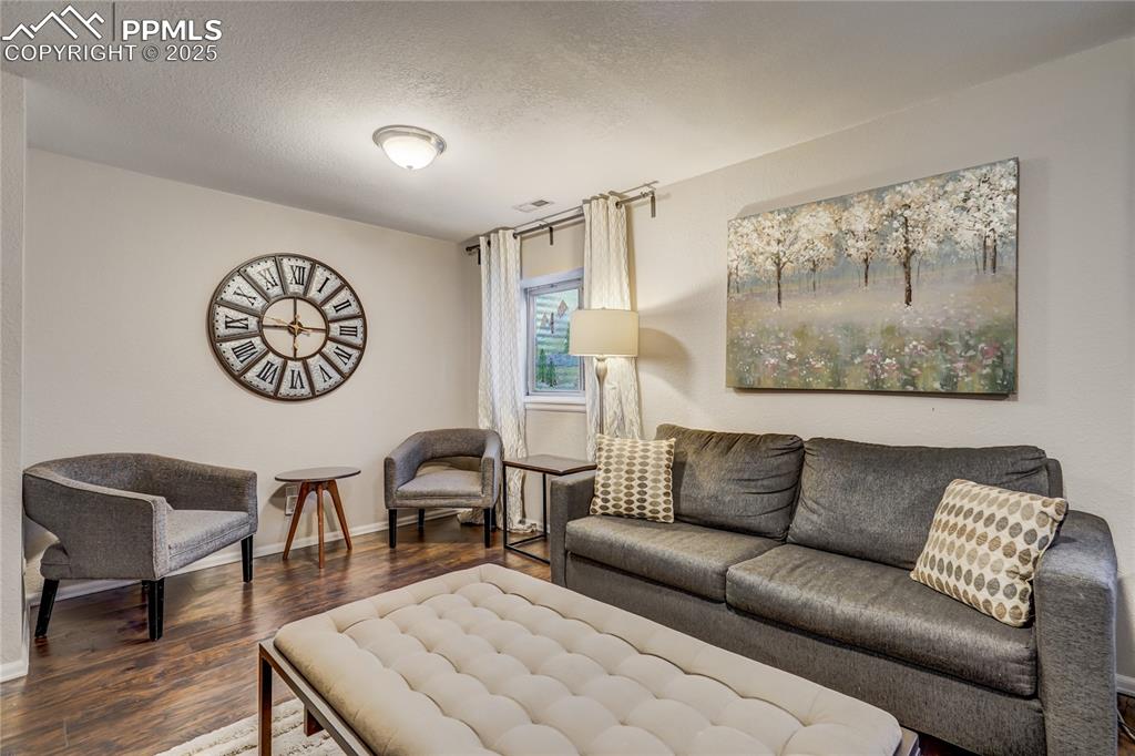 Image 24 of 35: Recreation room in the basement with good lighting, murial painted on the w