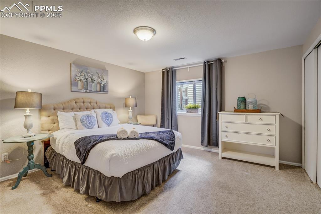 Image 26 of 35: 3rd bedroom located in the basement with good light coming in from the outs