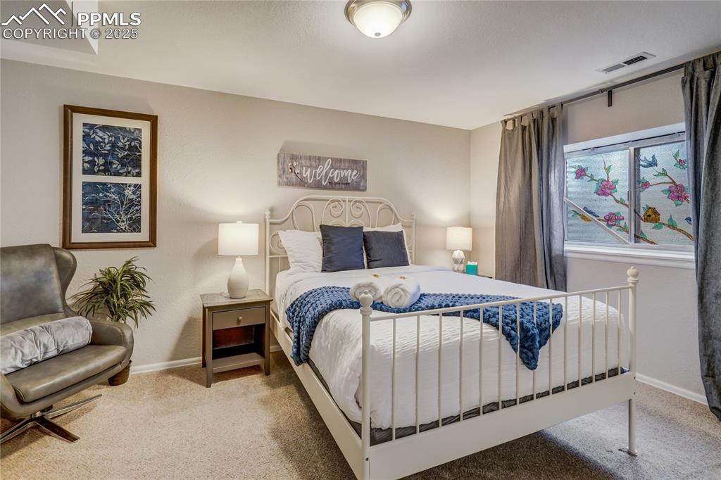 Image 28 of 35: 4th bedroom located in the basement with good light coming in from the outs