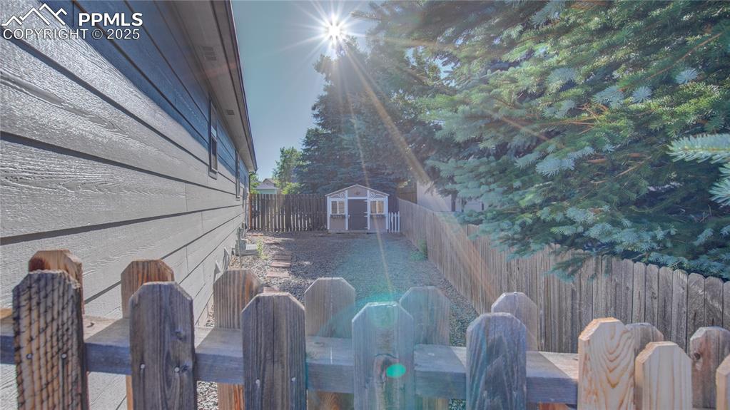 Image 35 of 35: Side of the house showing a super cute play house.