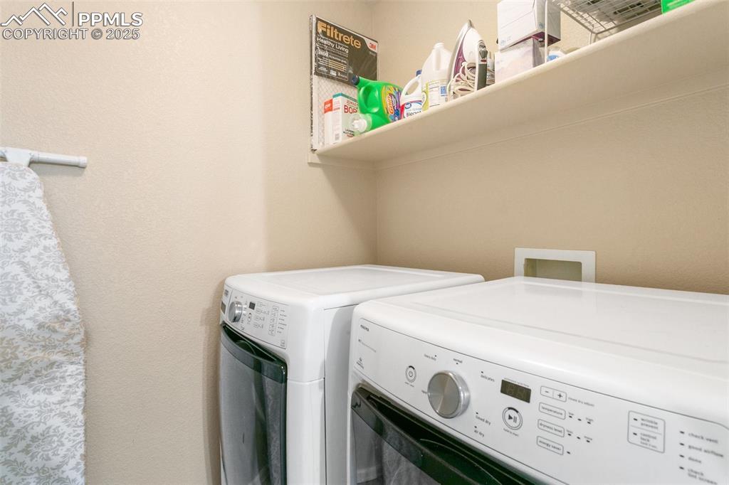 Image 24 of 46: Washroom featuring washer and dryer