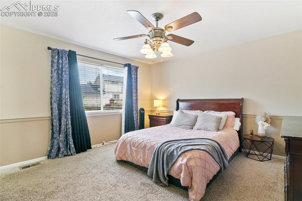 Image 27 of 46: Bedroom with carpet and a ceiling fan