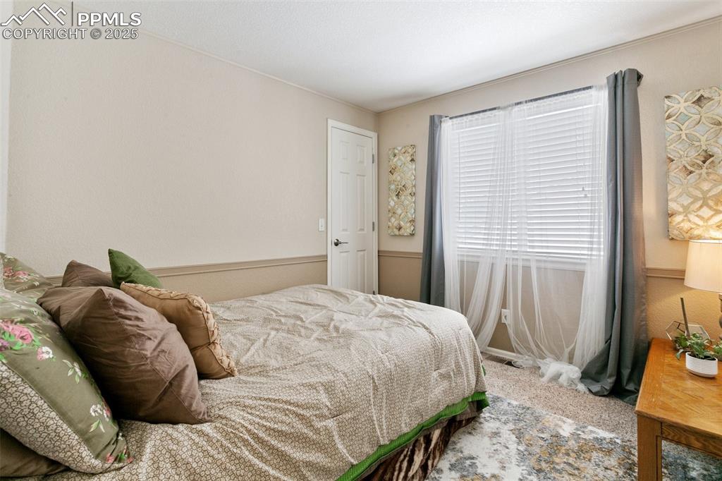 Image 37 of 46: Bedroom with carpet flooring