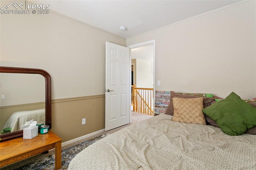 Image 38 of 46: Carpeted bedroom featuring baseboards