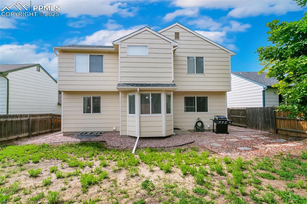 Image 45 of 46: Rear view of property with a fenced backyard