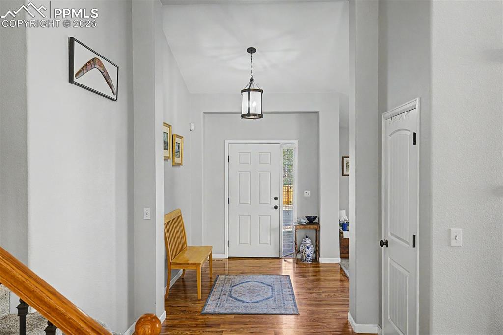 Image 2 of 49: Soaring ceilings and gleaming hardwood floors welcome you into a bright, ai