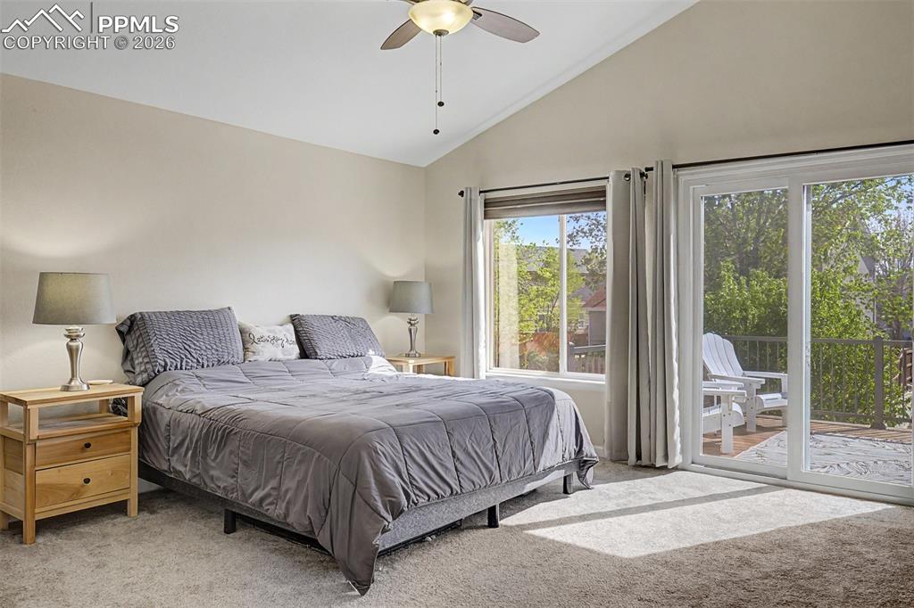 Image 21 of 49: The primary bedroom is a generous, light-filled sanctuary featuring vaulted