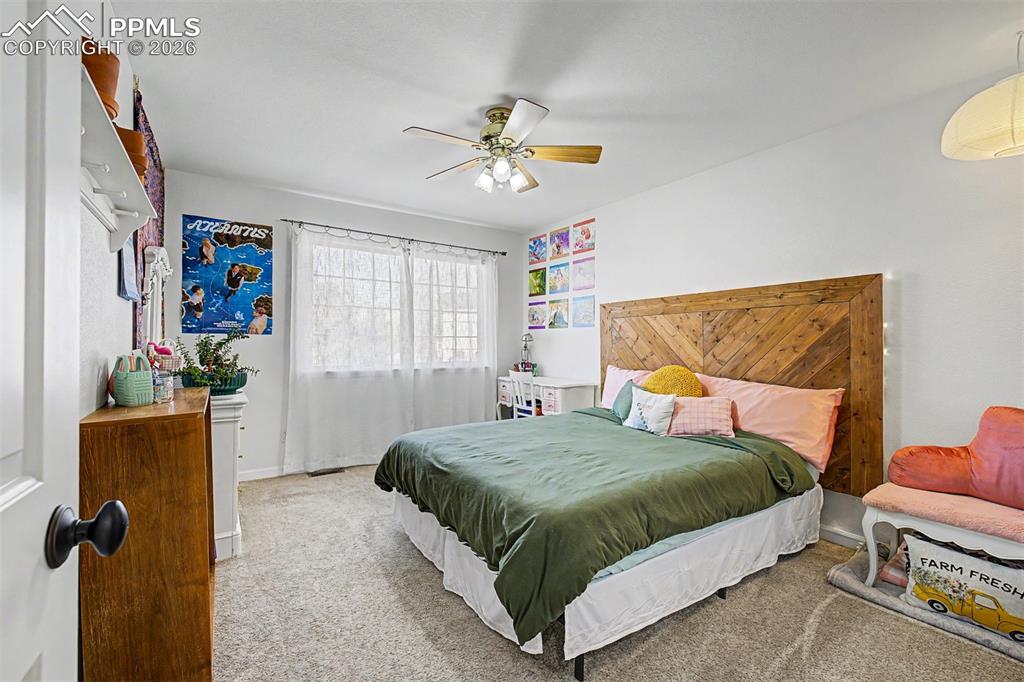 Image 26 of 49: A cheerful and personality-filled secondary bedroom.