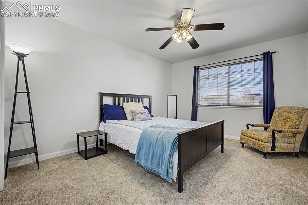 Image 28 of 49: A restful third bedroom is a comfortable retreat with just the right amount