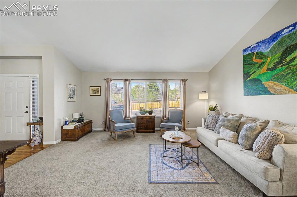 Image 3 of 49: The front living room is a peaceful retreat filled with natural light, feat
