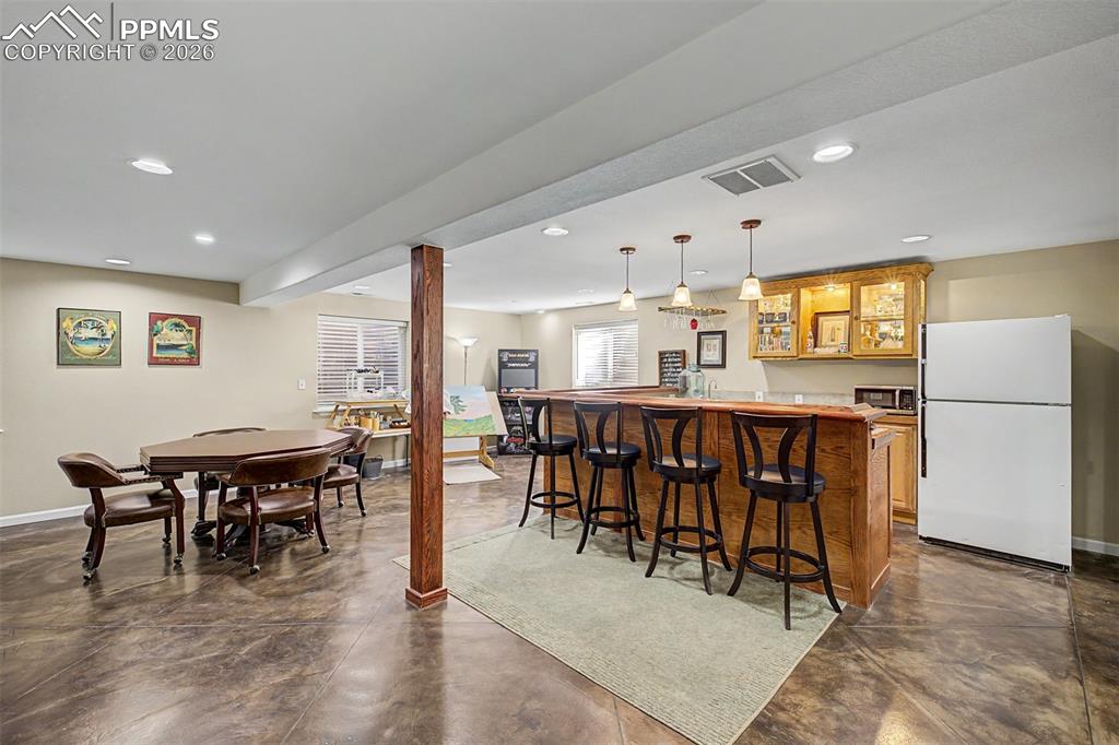 Image 31 of 49: The expansive basement rec room offers endless possibilities with a card ta