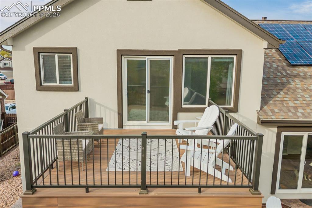 Image 34 of 49: The balcony off the primary bedroom is a private perch above the treetops. 