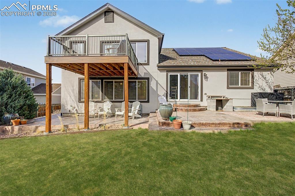Image 40 of 49: A full view of the rear of the home showcases the two-level outdoor living 