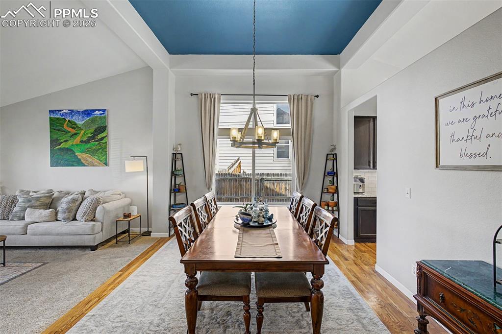 Image 6 of 49: The formal dining room steals the show with its dramatic deep-blue tray cei
