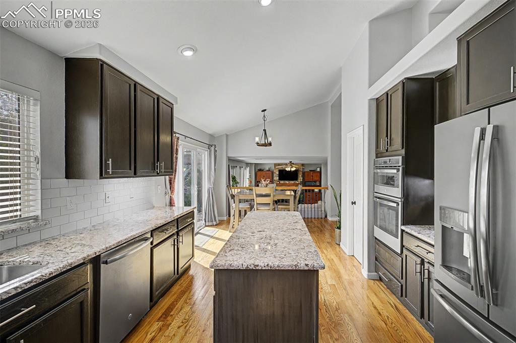 Image 9 of 49: Looking down the length of the kitchen from the island, the thoughtful layo