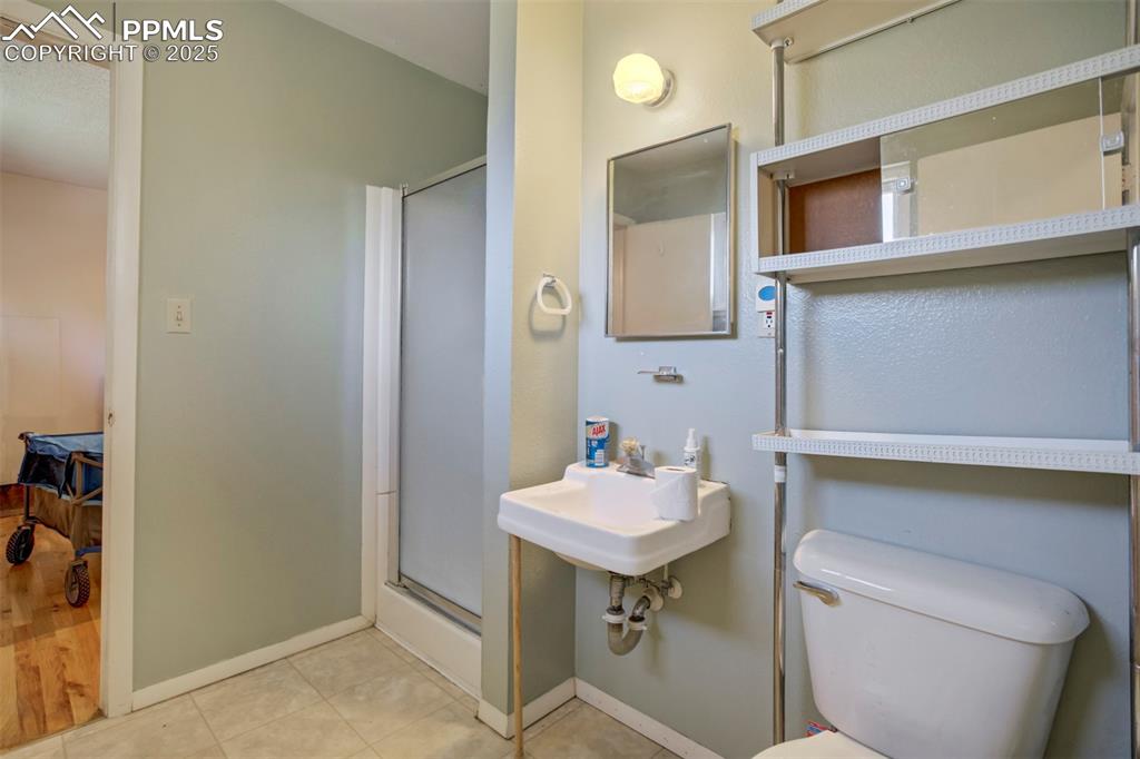 Image 13 of 38: Full bath featuring a stall shower and light tile patterned floors