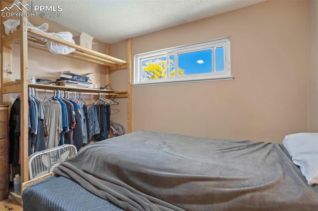 Image 16 of 38: Bedroom featuring a textured ceiling