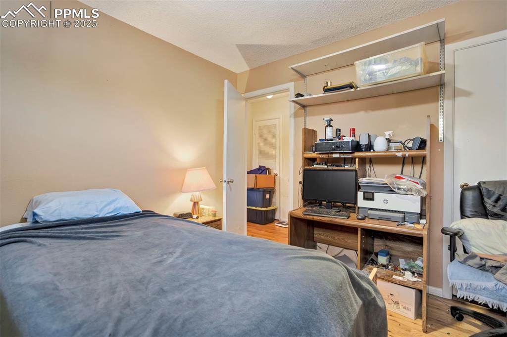 Image 17 of 38: Bedroom featuring light wood-style flooring and a textured ceiling
