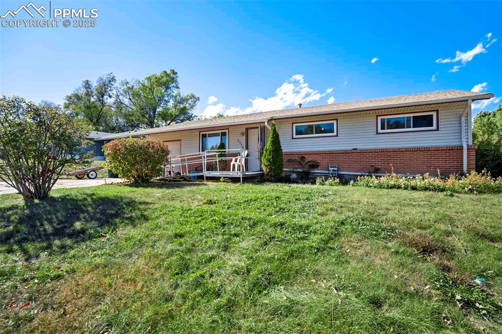 Image 2 of 38: Ranch-style home featuring brick siding and a front yard