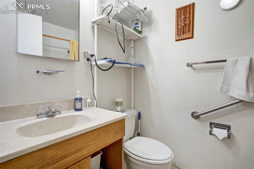 Image 25 of 38: Bathroom with vanity and a textured wall