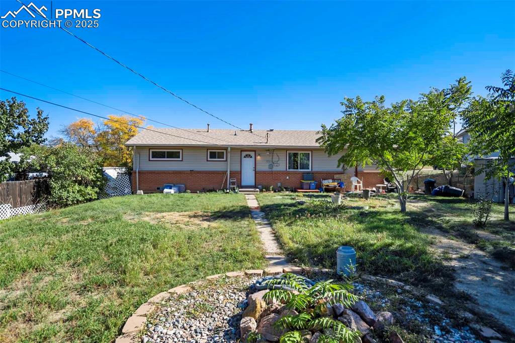 Image 29 of 38: View of front of house featuring brick siding