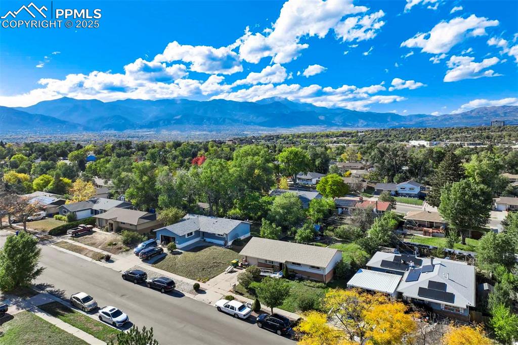 Image 31 of 38: Aerial view of residential area featuring a mountain backdrop