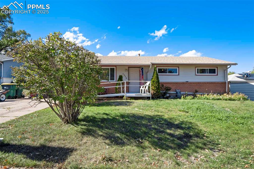 Image 37 of 38: Single story home featuring brick siding, a front yard, and a porch