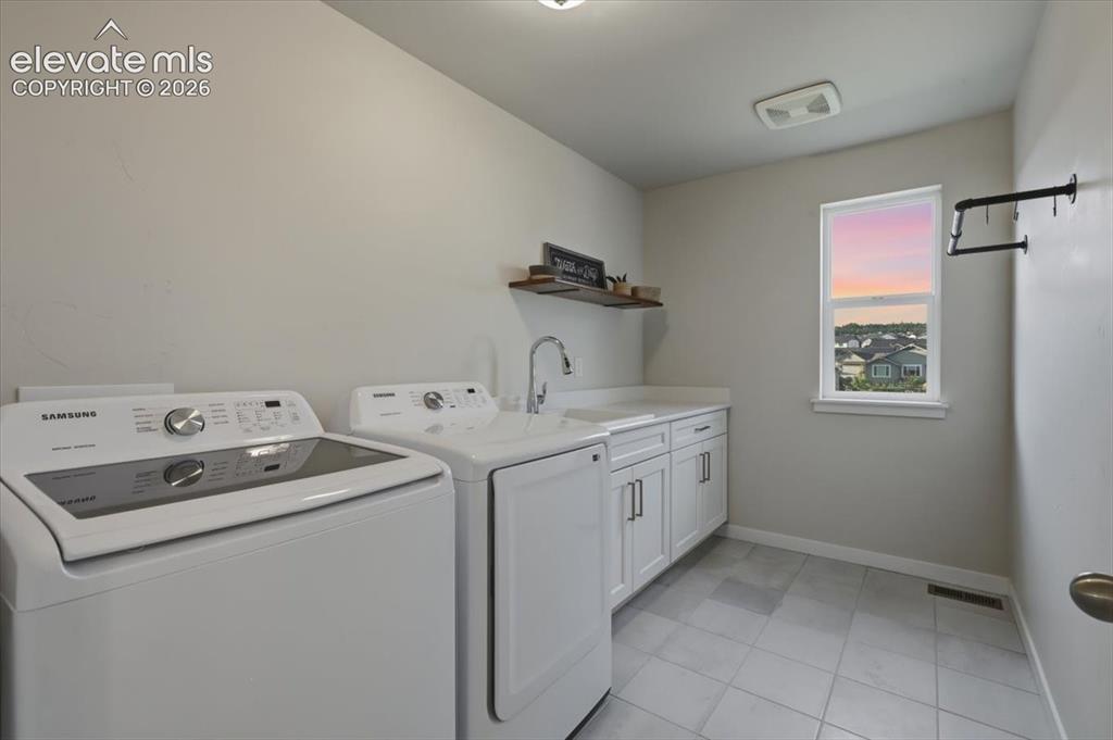 Image 24 of 50: Spacious Laundry w/ sink and folding table 