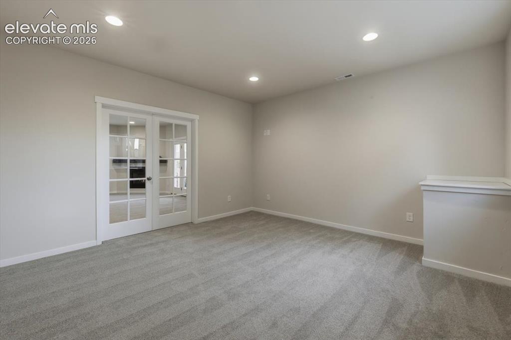 Image 41 of 50: 6th bedroom/flex space in basement off family room